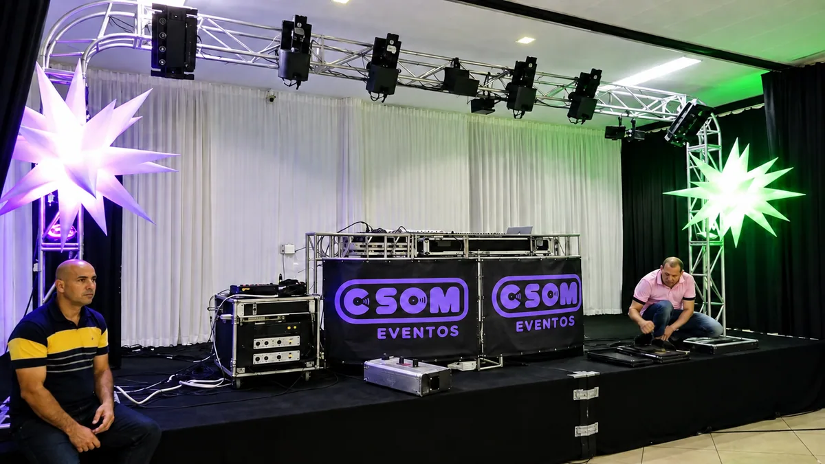 Estrutura ampla de truss e iluminação sobre a cabine identificada da CSOM