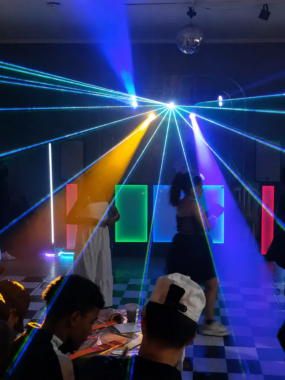 Themed dance floor with an illuminated booth, lasers and vivid colors